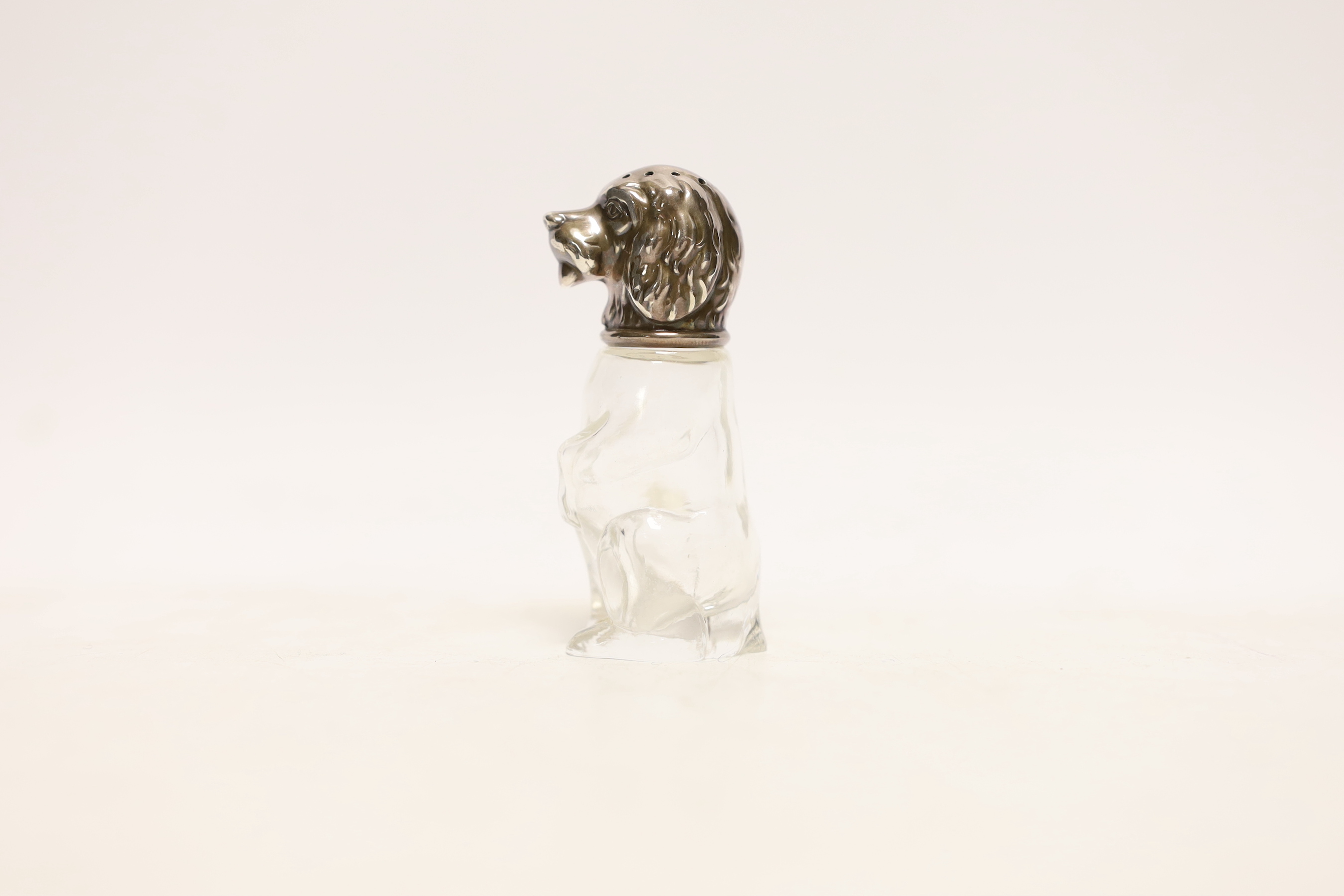 A continental novelty 900 standard white metal mounted glass pepperette, with dog's head cap, maker M&M, height 72mm.